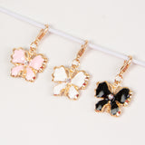 Enamel butterfly charm with rhinestone accent in pink, white or black.