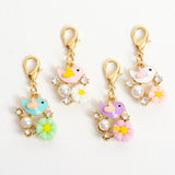 Enamel Bird and Flower Charm in Blue, White, Pink or Purple. Hangs from a 15mm light gold lobster claw clasp.