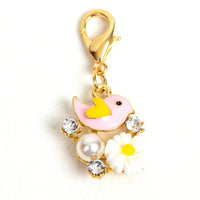 Pink bird and flower charm or stitch marker with yellow heart shaped wing, pink resin flower, rhinestones and acrylic pearl with light gold lobster claw clasp