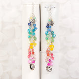 Afternoon Tea Dangle Charm with rainbow crystals shown on ring bound planner and traveler's notebook.