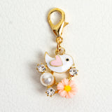 White Enamel Bird with pink heart shaped wing, pink resin flower, rhinestones and acrylic pearl
