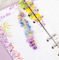 Wisteria charm shown with the Wisteria Lane Cocoa Daisy planner pages