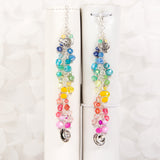 Afternoon Tea Dangle Charm with rainbow crystals shown on ring bound planner and traveler's notebook. 