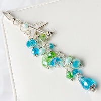Airplane charm with blue and green crystals